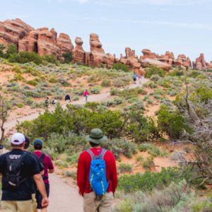 Hikers visit Arches National Park in Utah.